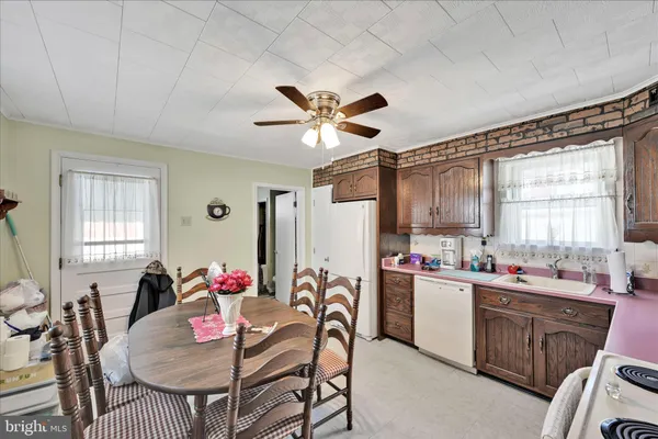 a view of a dining room with furniture and window