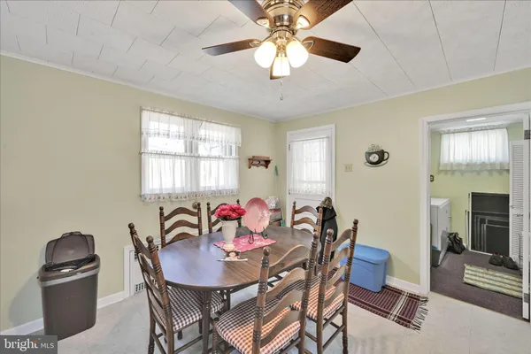 a view of a dining room with furniture and chandelier