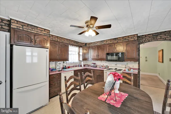 a kitchen with stainless steel appliances granite countertop a refrigerator a stove top oven a sink dishwasher and a refrigerator