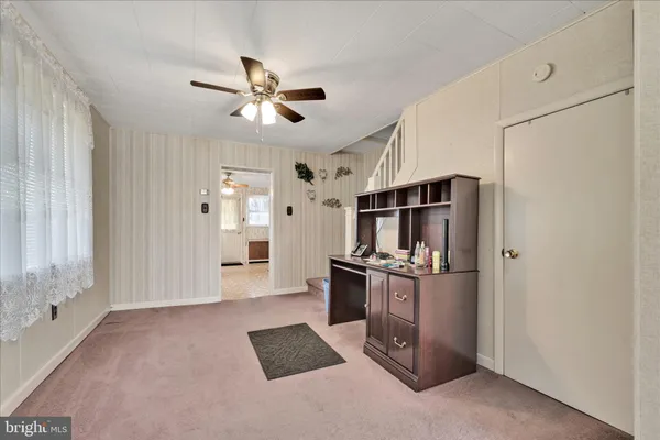 a view of a kitchen with refrigerator and ceiling fan