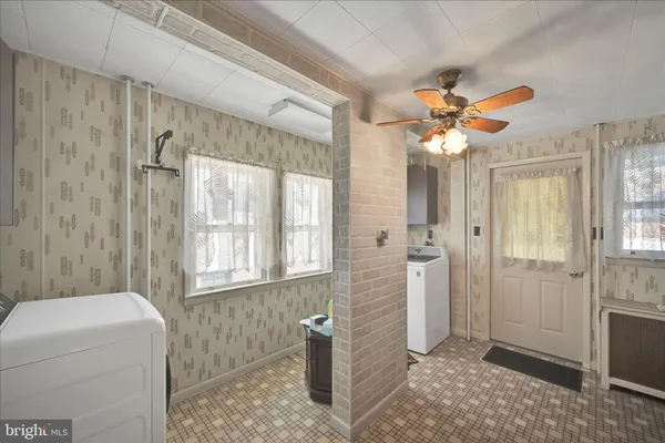 a bathroom with a granite countertop sink a mirror and a shower
