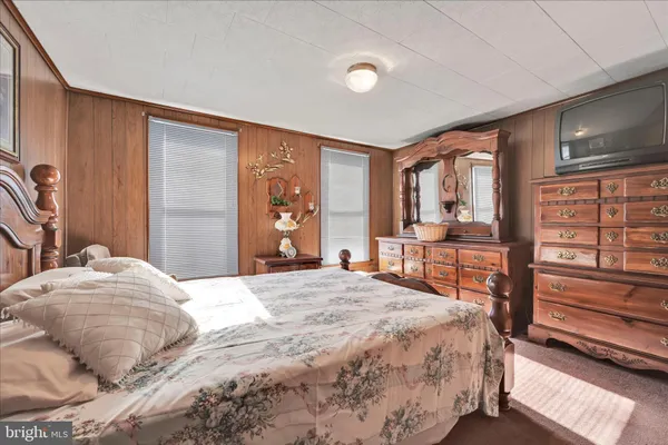 a bedroom with a large bed and a large window