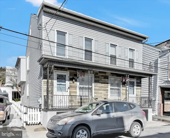 a front view of a house with parking space