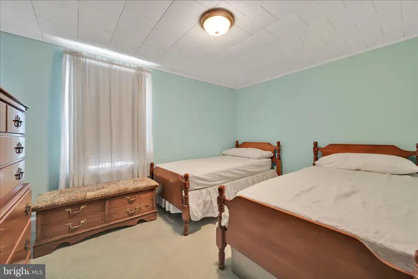 a bedroom with two beds and painted walls