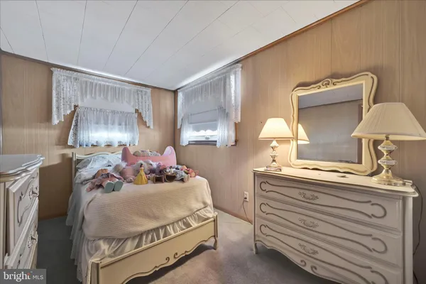 a bedroom with a bed and a mirror