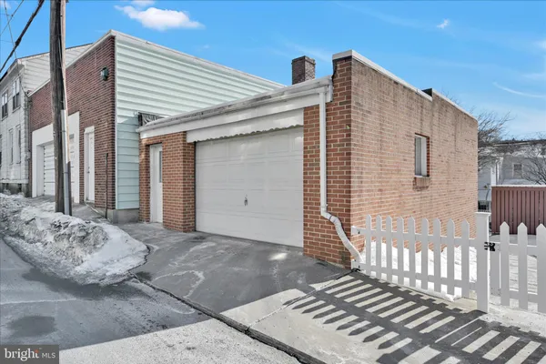 a view of a wooden house with wooden fence
