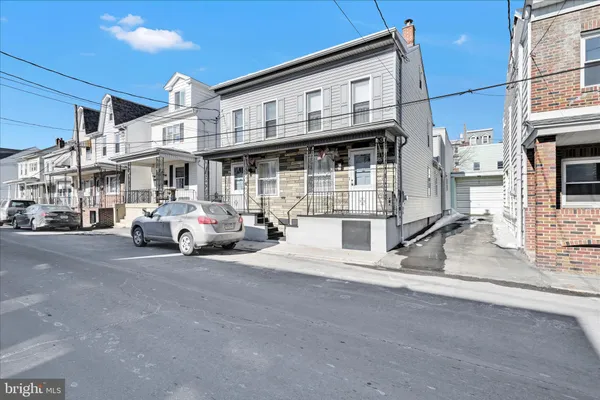 a view of a street with parked cars