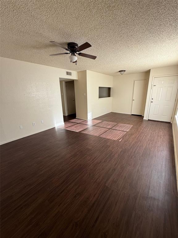 1713 Short Street, Unit A Cleburne, TX 76033 - Photo 2 of 8 an empty room with wooden floor ceiling fan and windows