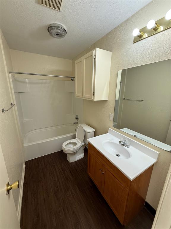 1713 Short Street, Unit A Cleburne, TX 76033 - Photo 6 of 8 a bathroom with a sink a toilet and a mirror