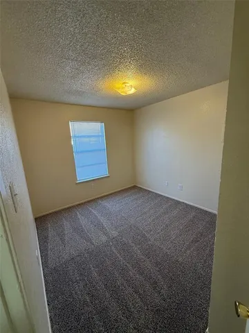 a view of an empty room and a window