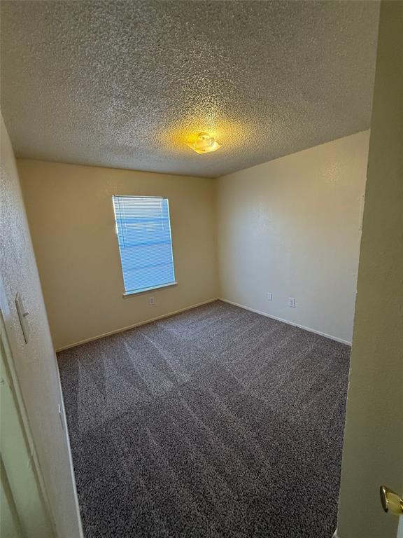 1713 Short Street, Unit A Cleburne, TX 76033 - Photo 8 of 8 a view of an empty room and a window