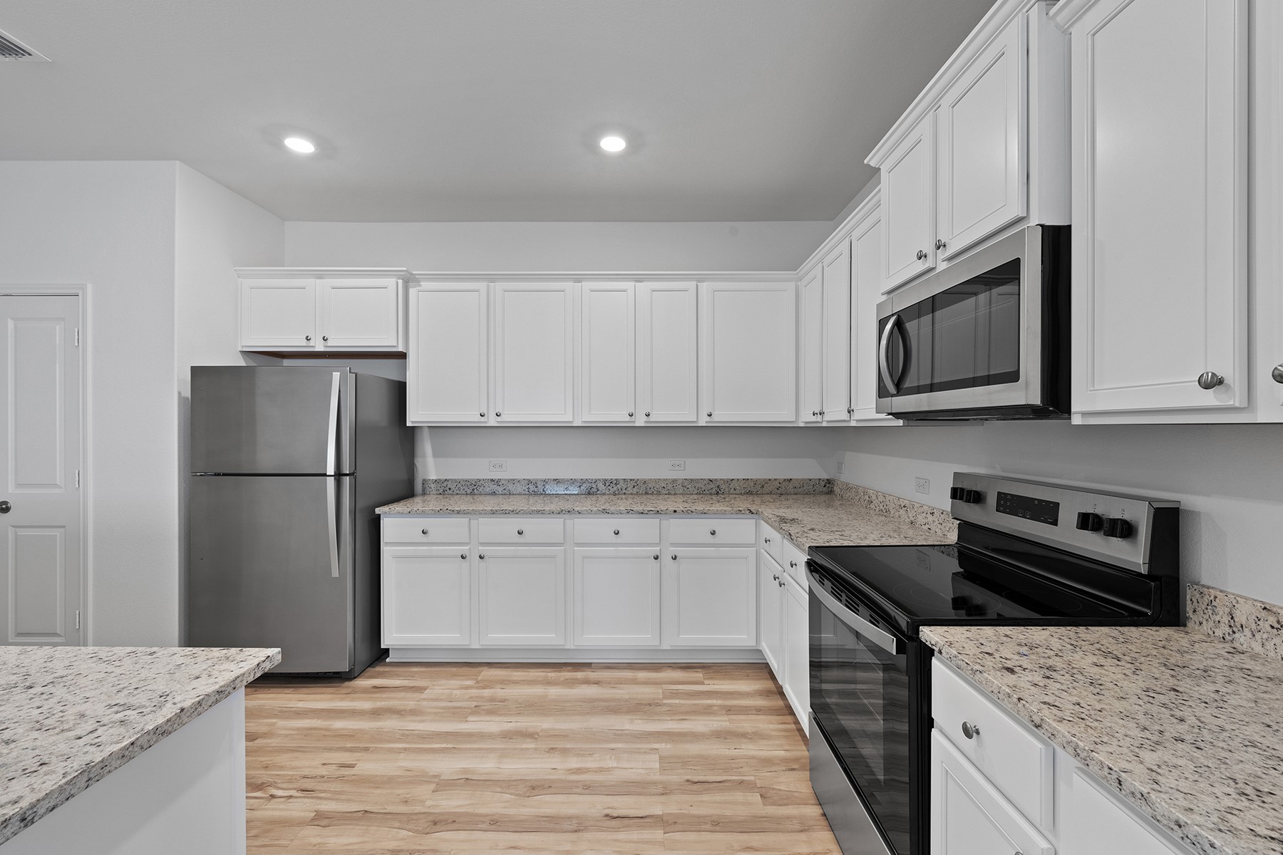 14520 Wahlbergs Way Elgin, TX 78621 - Photo 3 of 13 a kitchen with a sink stove and refrigerator