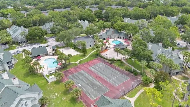 an aerial view of residential houses with outdoor space and river