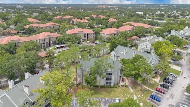 an aerial view of residential houses with outdoor space and parking