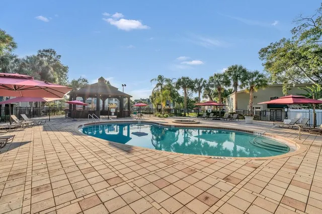 a view of a patio with a table and chairs under an umbrella