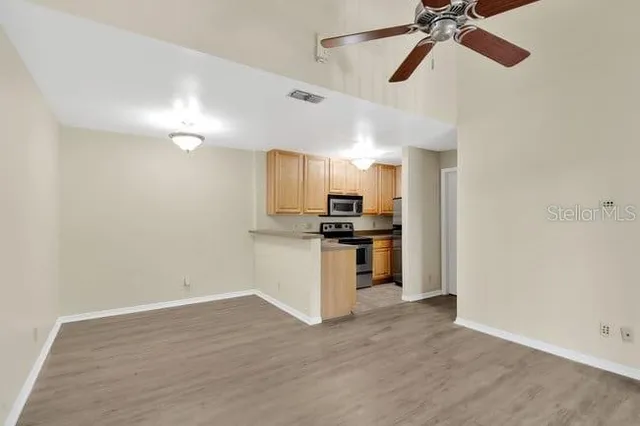 a view of empty room with wooden floor