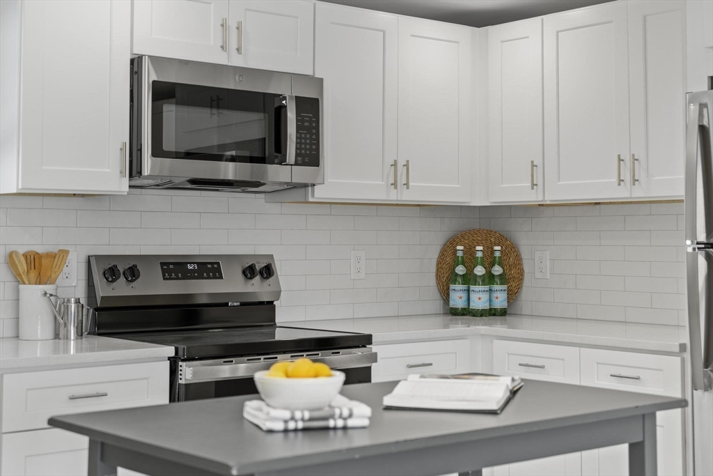 68 East Street Hanover, MA 02339 - Photo 13 of 39 a kitchen with a stove and a microwave