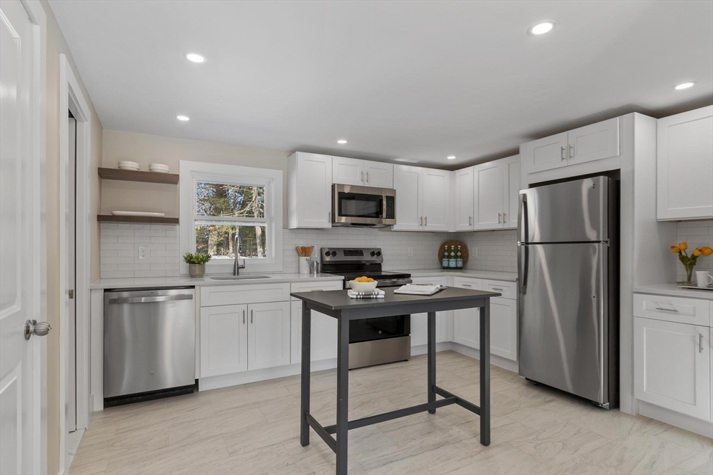 68 East Street Hanover, MA 02339 - Photo 14 of 39 a kitchen with stainless steel appliances a refrigerator stove microwave and sink
