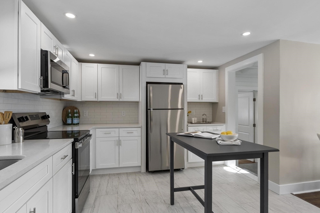 68 East Street Hanover, MA 02339 - Photo 15 of 39 a kitchen with refrigerator cabinets and wooden floor