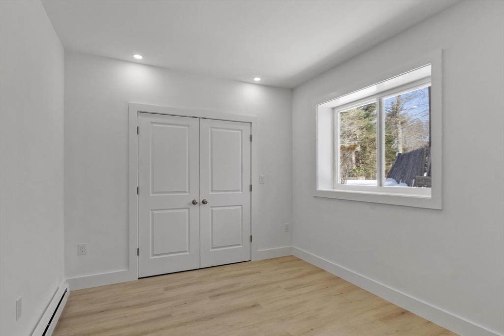 68 East Street Hanover, MA 02339 - Photo 33 of 39 a view of an empty room with wooden floor and a window