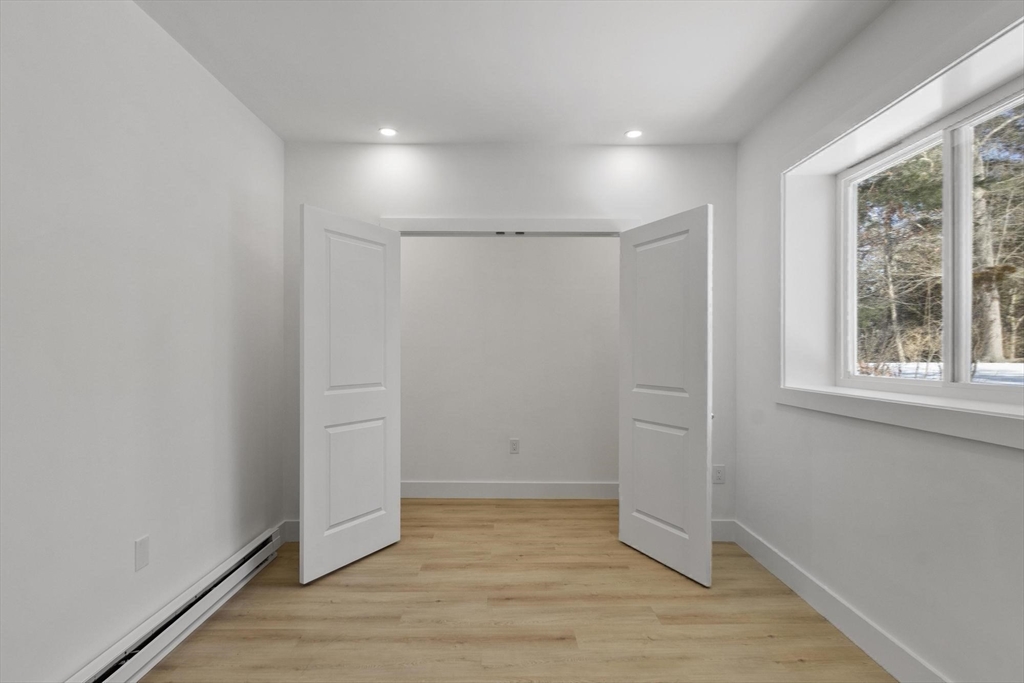 68 East Street Hanover, MA 02339 - Photo 34 of 39 an empty room with wooden floor and windows