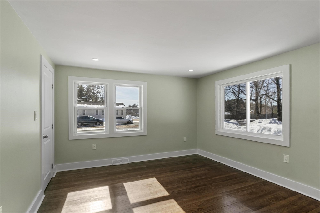 68 East Street Hanover, MA 02339 - Photo 35 of 39 a view of an empty room with wooden floor and a window