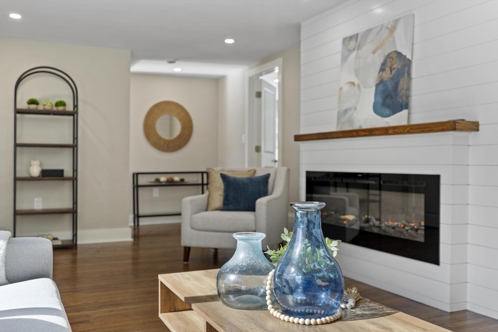 68 East Street Hanover, MA 02339 - Photo 9 of 39 a living room with furniture and a fireplace