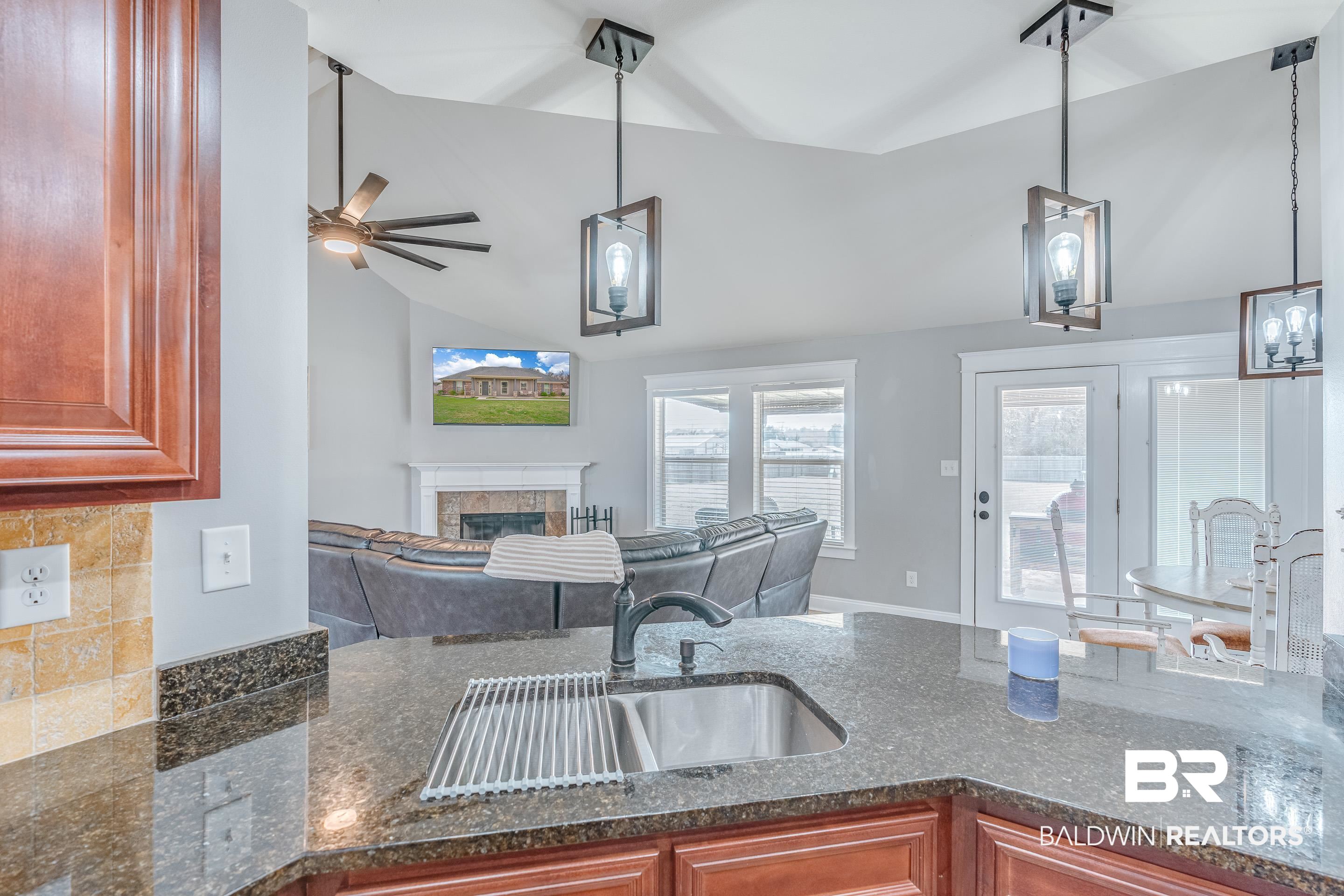 13235 Tom Gaston Road Mobile, AL 36695 - Photo 13 of 43 Kitchen with lofted ceiling, sink, decorative light fixtures, and ceiling fan