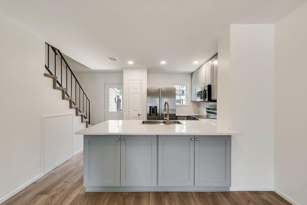 28 Abbey Road Euless, TX 76039 - Photo 7 of 19 Kitchen island with light blue cabinetry and a white countertop