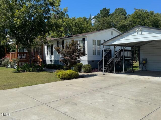 1302 Rocky Ford Road Louisburg, NC 27549 - Photo 12 of 26 a front view of a house with a garden