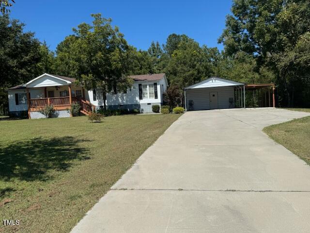 1302 Rocky Ford Road Louisburg, NC 27549 - Photo 2 of 26 a front view of a house with a garden and trees