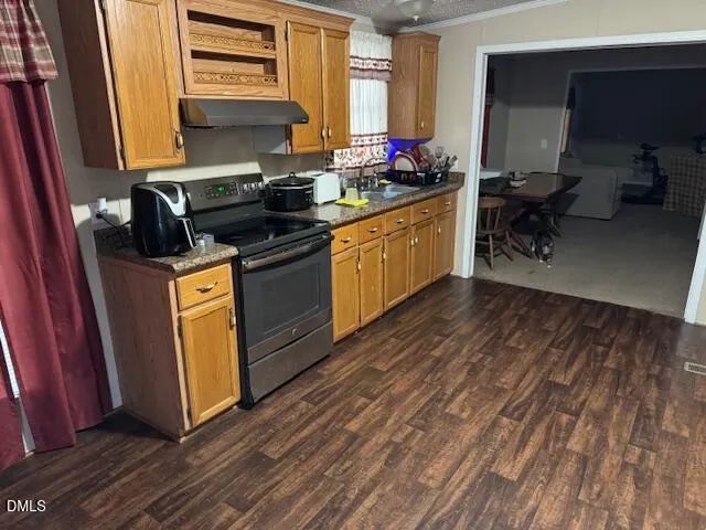a kitchen with stainless steel appliances a refrigerator and a stove top oven