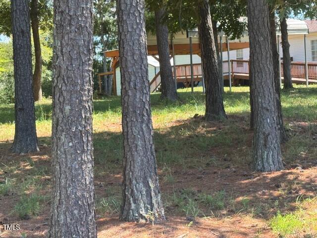 1302 Rocky Ford Road Louisburg, NC 27549 - Photo 9 of 26 a backyard of a house with lots of green space