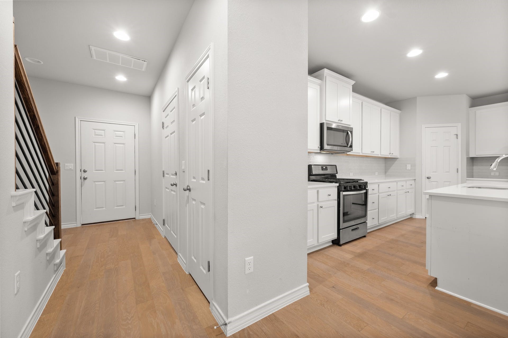 5107 Lemon Tree Path, Unit 127 Austin, TX 78723 - Photo 14 of 40 a kitchen with white cabinets and stainless steel appliances