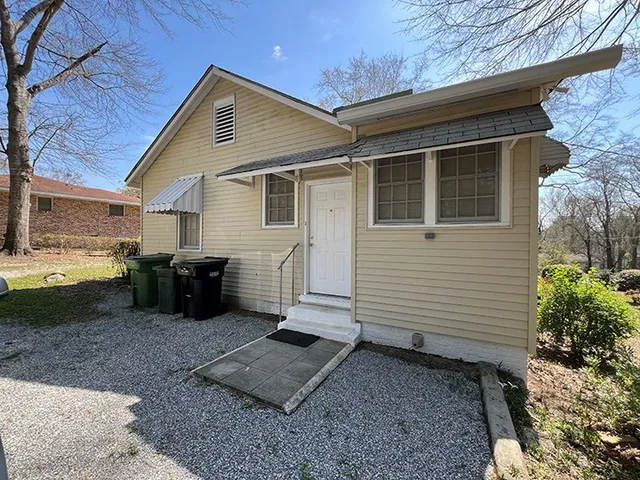 a view of a backyard with plants and a patio