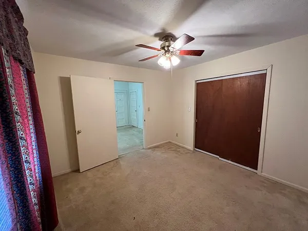 a view of an empty room with a fan