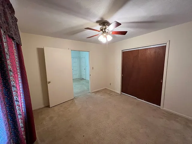 a view of an empty room with a fan