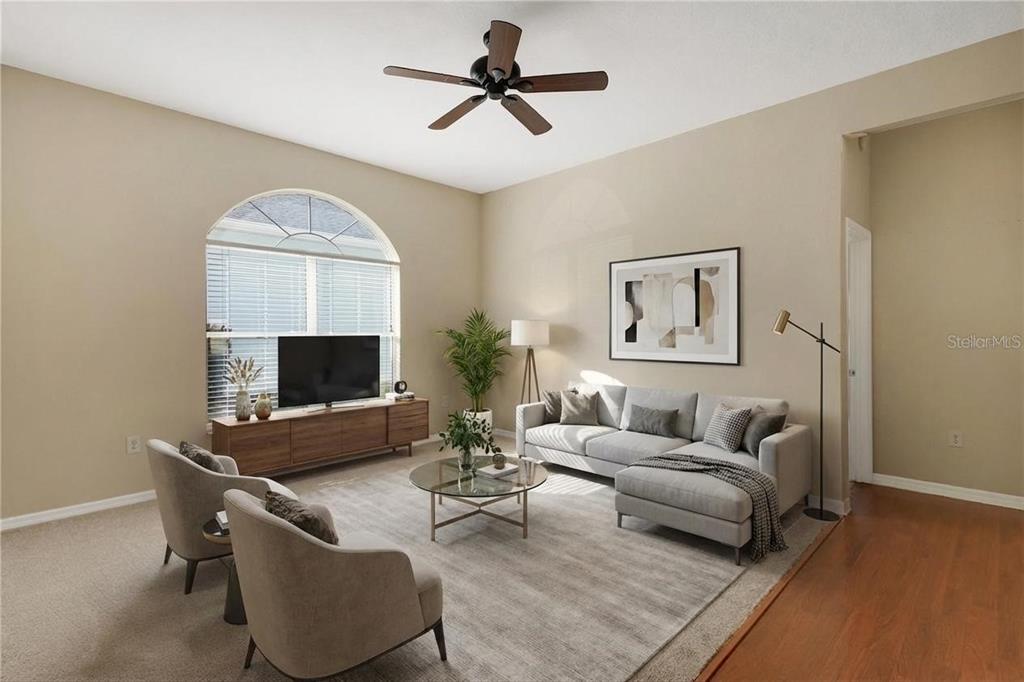 3715 Mulberry Grove Loop Leesburg, FL 34748 - Photo 13 of 48 a living room with furniture and a flat screen tv