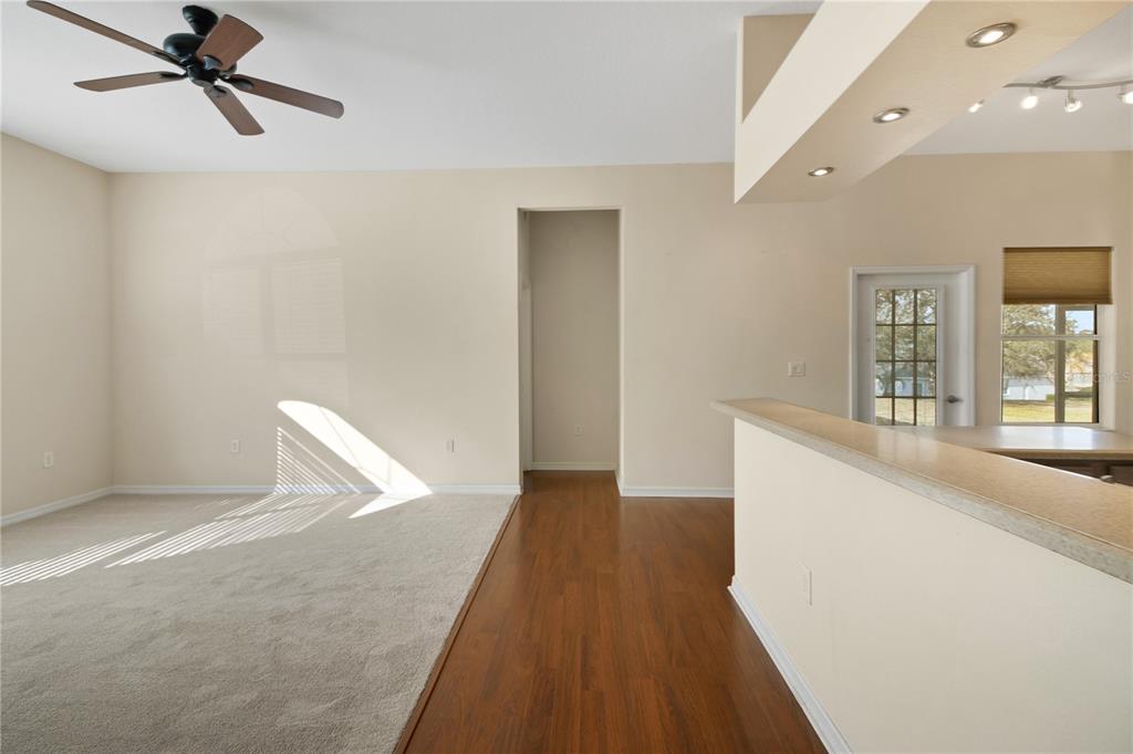 3715 Mulberry Grove Loop Leesburg, FL 34748 - Photo 14 of 48 a view of a big room with wooden floor and windows