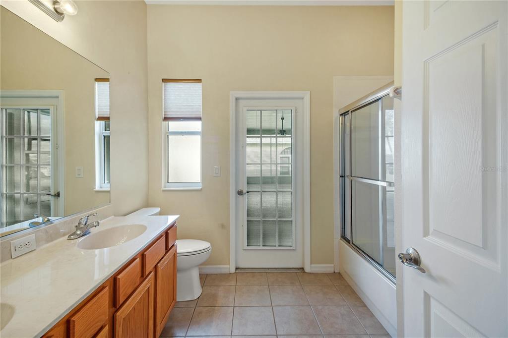 3715 Mulberry Grove Loop Leesburg, FL 34748 - Photo 18 of 48 a spacious bathroom with a double vanity sink toilet and shower