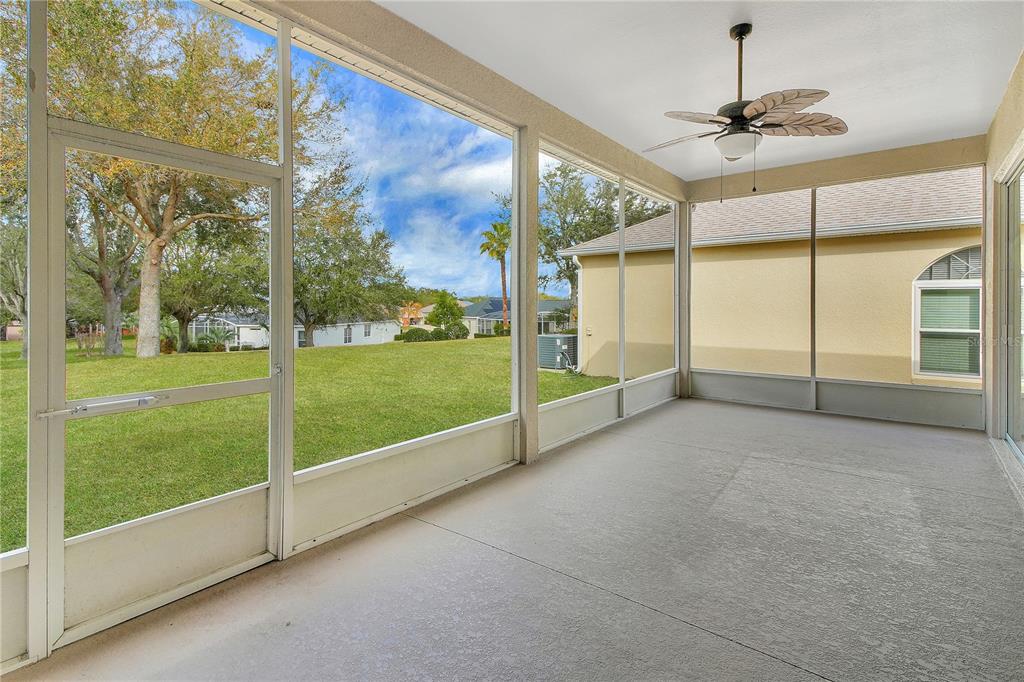 3715 Mulberry Grove Loop Leesburg, FL 34748 - Photo 20 of 48 a view of an empty room with a floor to ceiling window and an outdoor view