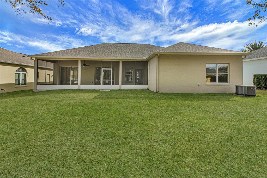 3715 Mulberry Grove Loop Leesburg, FL 34748 - Photo 23 of 48 front view of a house with a garden