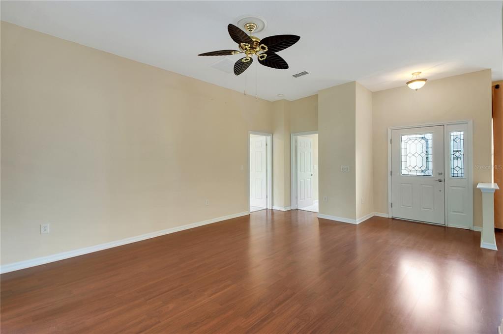 3715 Mulberry Grove Loop Leesburg, FL 34748 - Photo 26 of 48 a view of an empty room with wooden floor and a window