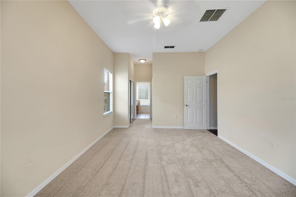 3715 Mulberry Grove Loop Leesburg, FL 34748 - Photo 28 of 48 wooden floor in an empty room with a bathroom