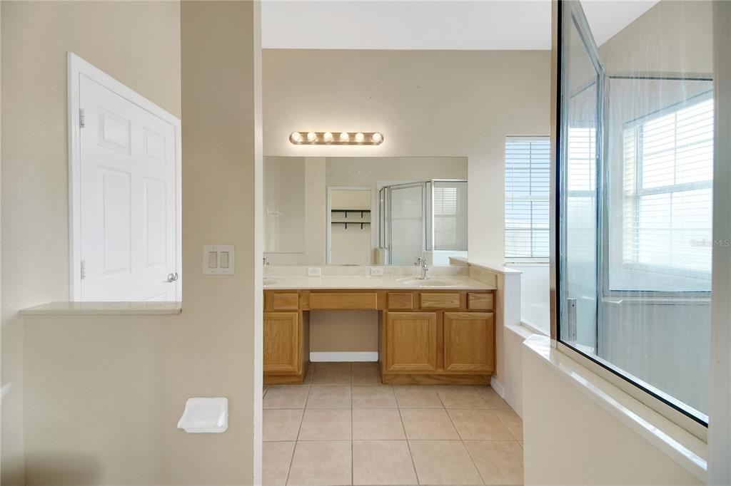 3715 Mulberry Grove Loop Leesburg, FL 34748 - Photo 34 of 48 a bathroom with a sink and a mirror