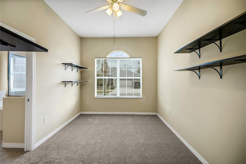3715 Mulberry Grove Loop Leesburg, FL 34748 - Photo 36 of 48 an empty room with a window and chandelier
