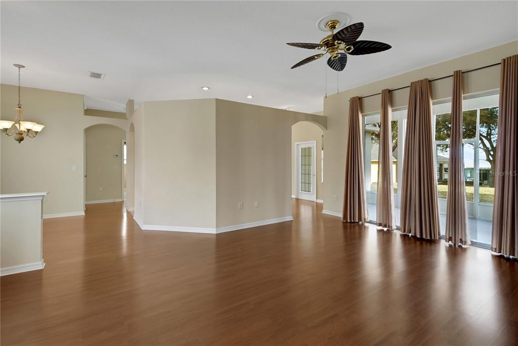 3715 Mulberry Grove Loop Leesburg, FL 34748 - Photo 39 of 48 a view of an empty room with a window and wooden floor