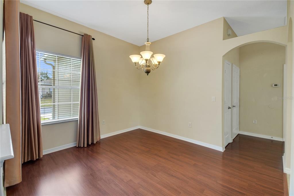 3715 Mulberry Grove Loop Leesburg, FL 34748 - Photo 41 of 48 a view of a chandelier in big room and wooden floor