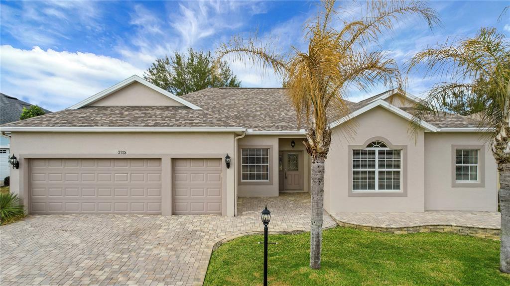 3715 Mulberry Grove Loop Leesburg, FL 34748 - Photo 47 of 48 a front view of a house with a garden and yard