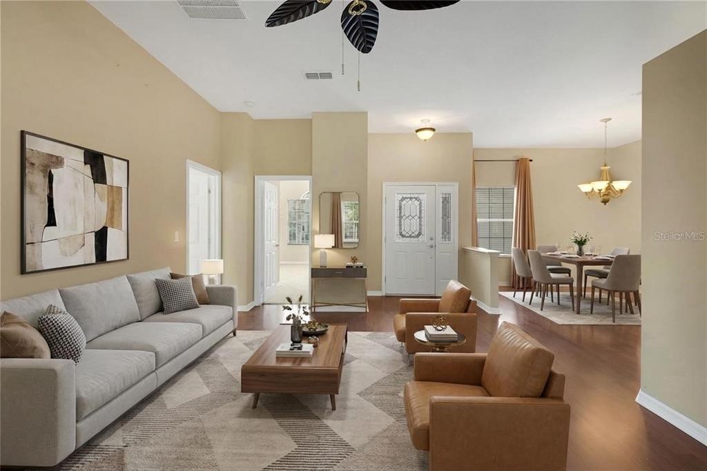 3715 Mulberry Grove Loop Leesburg, FL 34748 - Photo 5 of 48 a living room with furniture or outdoor view and a chandelier
